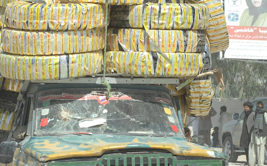 Vehicles overloaded with all manner of goods cross the border between Afghanistan and Pakistan at the down of Wesh in Spin Boldak district. U.S. soldiers there suspect large amounts of bomb making chemicals are being smuggled into the country amongst other imports.