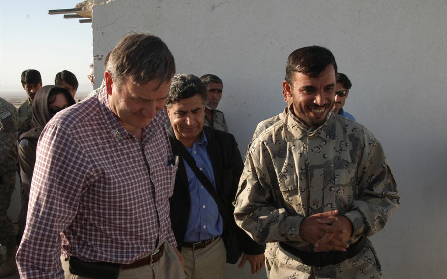 U.S. Ambassador to Afghanistan Karl Eikenberry, left, talks with Afghan Border Patrol commander Col. Abdul Razziq at the Afghanistan-Pakistan border Nov. 1, 2010. Eikenberry visited the border to look over what is being done to tighten security and fight the Taliban smuggling of explosives into Afghanistan.
