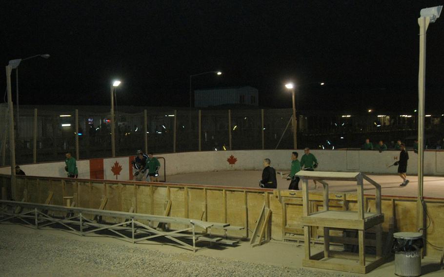 American servicemembers scrimmage against each other in preparation for the upcoming ball hockey season at Kandahar Airfield in southern Afghanistan. The rink is one of the unusual sights at the KAF boardwalk, where visitors and residents can shop or dine at about two-dozen shops and restaurants, or play a variety of sports in the common area in the middle of the boardwalk square.