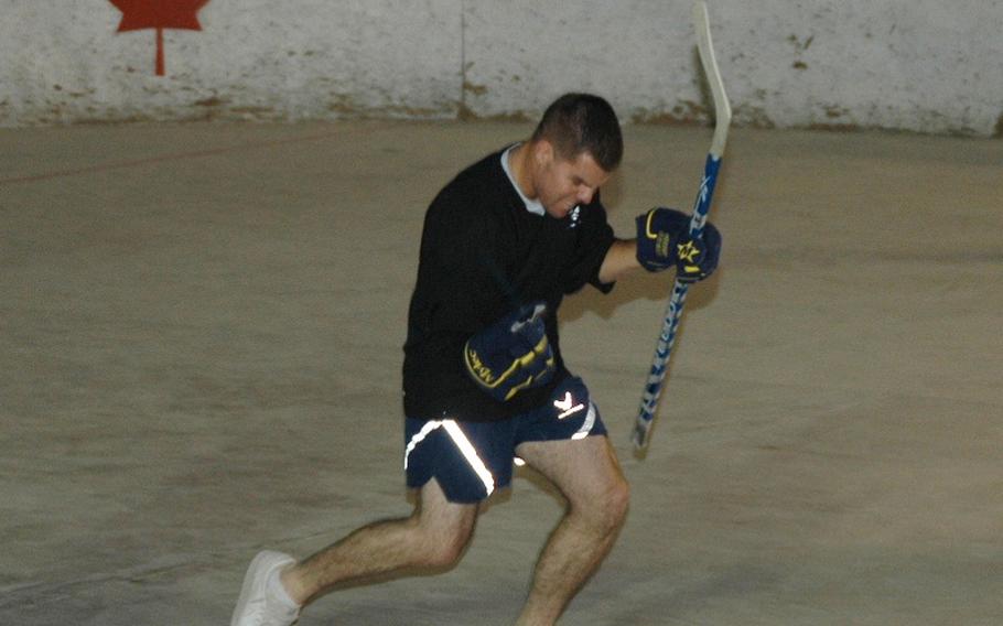 Airman 1st Class Ryan Dukett celebrates a goal with what he called his 'Tiger Woods fist-pump' during a scrimmage of American players preparing for the upcoming season of the Kandahar Hockey League, a ball hockey organization based at Kandahar Air Field in southern Afghanistan.