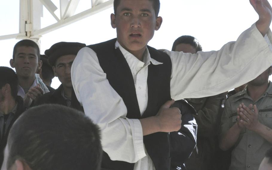 An Afghan police recruit dances in a circle Tuesday during celebrations for Islam's Eid al-Adha holiday at the Adraskan National Training Center in western Afghanistan.