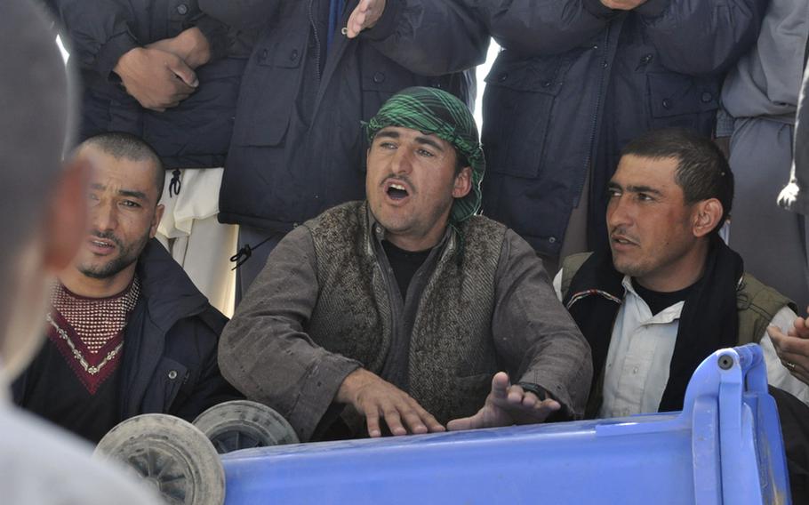 A holiday is always a time for celebration. And during the first day of the Eid al-Adha holiday Tuesday, an Afghan police recruit drummed out a beat for his brethren to dance to on a trash dumpster at the Adraskan National Training Center in western Afghanistan.