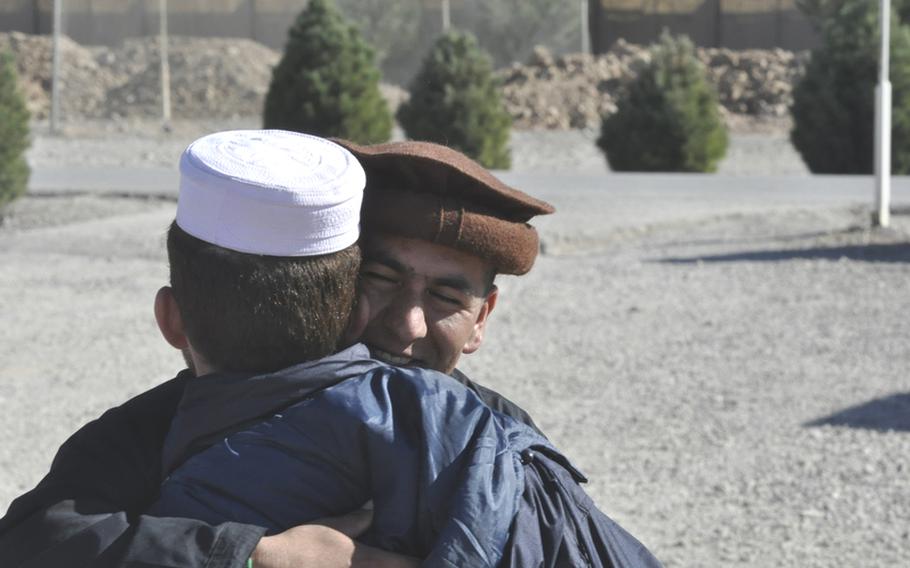 Two police recruits hug their hellos Tuesday during the first day of the Eid al-Adha holiday at Adraskan National Training Center in Afghanistan. The Muslim holiday marks the end of the annual pilgrimage to Mecca and is a time for sacrifice and helping others.
