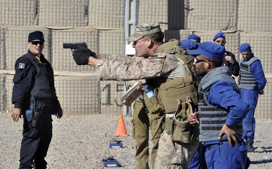 ADRASKAN NATIONAL TRAINING CENTER, Afghanistan
Marine Cpl. Joshua Zarr gives some pistol tips to an Afghan police recruit Nov. 7 at the Adraskan National Training Center in Afghanistan&#39;s Herat province. Zarr is a helicopter mechanic by trade but volunteered to come train the Afghans.