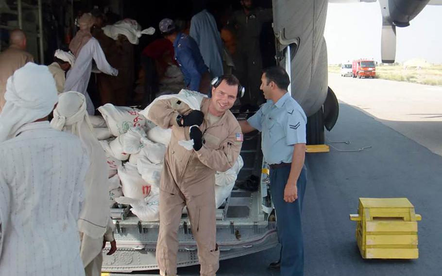 New York Air National Guard Staff Sgt. Anthony Legotti helps unload humanitarian aid in Pakistan during the U.S. military relief effort in the wake of devastating floods in the country this summer.