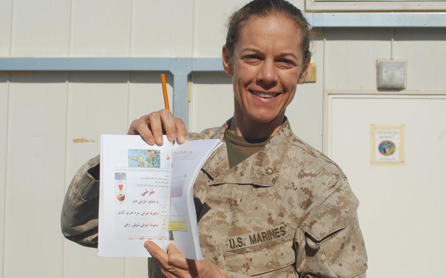 Maj. Nina D'Amato is hoping to teach thousands of illiterate and house-bound Afghan women to read with a daily radio broadcast, a booklet and instructions on how to hold a pencil. "If they're not going to come to us, we'll go to them," she said.