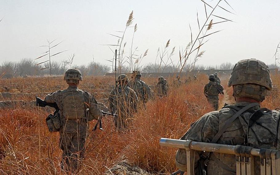 101st Airborne soldiers patrol in western Zhari through grape fields with vines that are dead for the winter. The military says it won't be able to judge the success of its fall clearing operations in Kandahar until the grape and pomegranate fields are once again lush, harkening the start of the traditional fighting season.