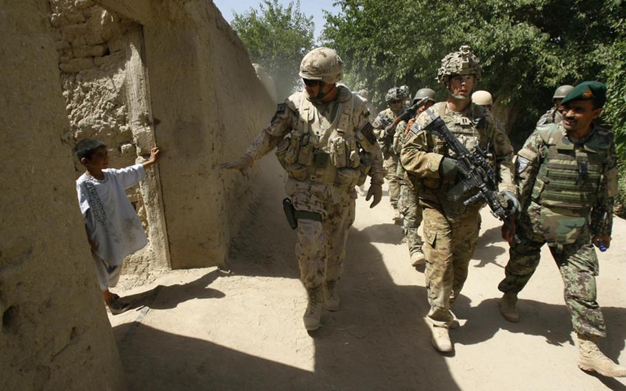U.S. troops, Afghan army soldiers and local policemen patrol the village of Sarkilla near Combat Out Post Nalgham, Afghanistan, on Sunday.