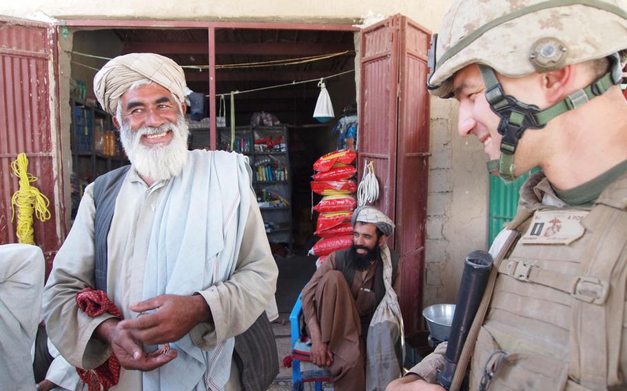 Marine Capt. Mike Regner, commander of Company G, 2nd Battalion, 3rd Marine Regiment, talks with a local in the main bazaar of Nawa district, Helmand province.