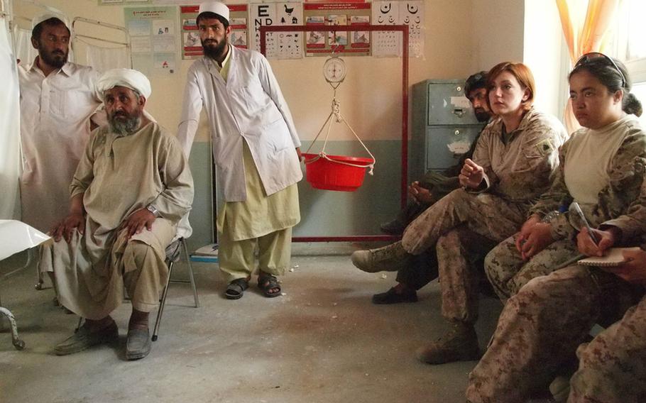 Female Engagement Team Marines and representatives from a British-run district support team and a Marine civil affairs group visit with medical staff at a clinic in Nawa's district center May 7, 2011. Nawa is among the districts most ready for handover to Afghan authorities in Helmand province.