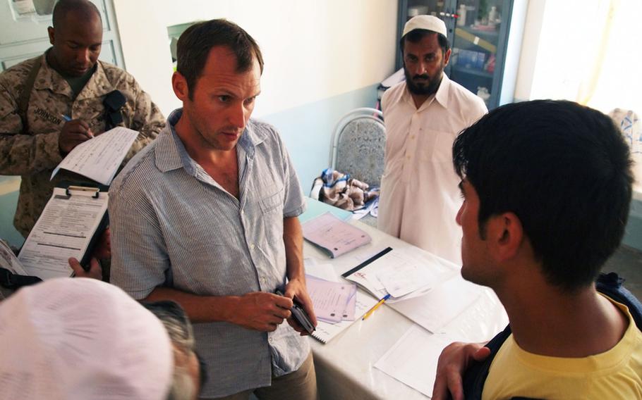 Phillip Horne, who served briefly as the stabilization adviser for a British district stabilization team in Nawa, and Marines from a female engagement team and a civil affairs group tour a clinic in Nawa's district center May 7, 2011.
