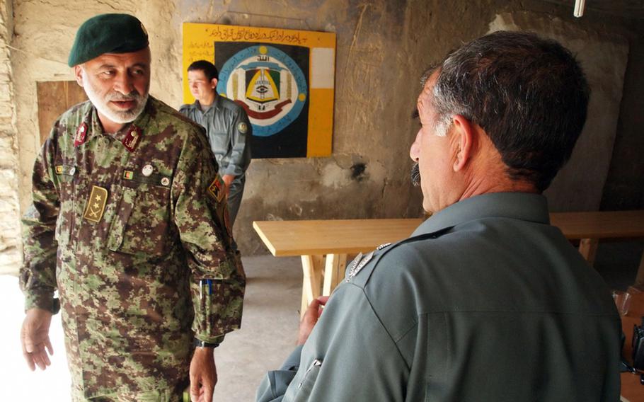 Gul Aman, commander of the Afghan National Army kandak in Nawa, meets with Nawa's District Chief of Police Maj. Sayfullah on May 11, 2011. Sayfullah and Aman are said to have a good working relationship, though there are occasional tensions between Afghan soldiers and police.