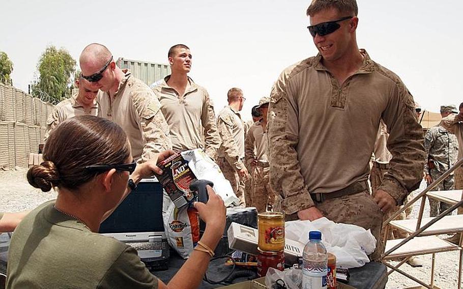 Marine Sgt. Amy Hastie rings up cigarettes, workout supplements, chips, dip, energy drinks and candy bars for a Marine visiting the mobile PX at Patrol Base Jaker, Afghanistan, on May 10.

Matt Millham/Stars and Stripes

May 10, 2011