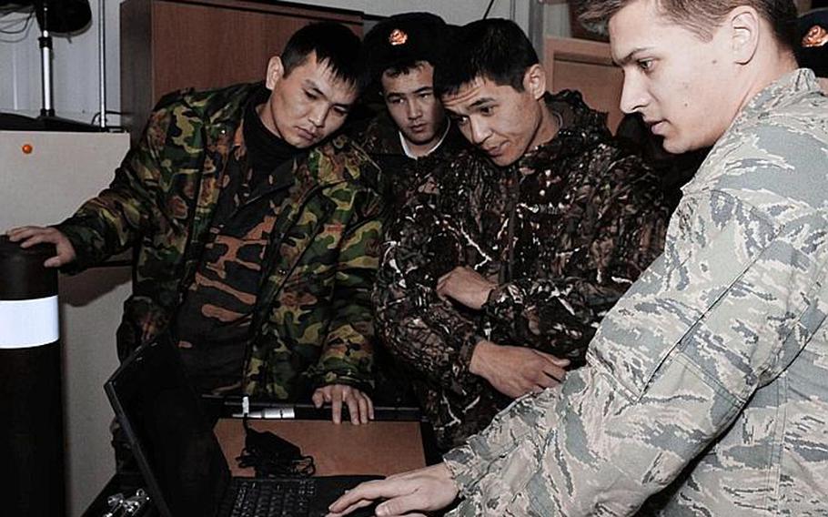 Staff Sgt. Joseph Hamski shows Kyrgyz army explosive ordnance disposal technicians how a computerized X-ray machine is used to see inside packages during a subject matter information exchange in March 2010 at the Transit Center at Manas, Kyrgyzstan.