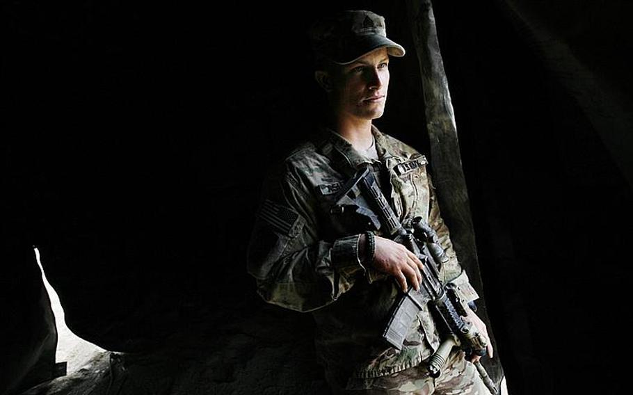 Squad leader Sgt. Kyle Ashton looks out from a tent Saturday at Combat Outpost Nalgham, Afghanistan. Ashton and other members of Scout platoon fought off attackers after their convoy was attacked in Kandahar province.