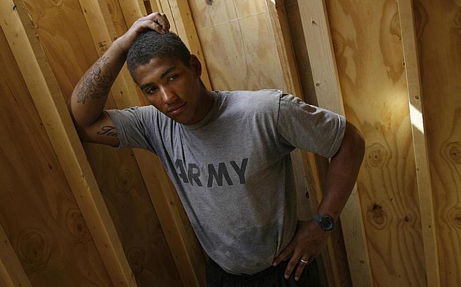 Pfc. Broderick Booker pauses Saturday at Combat Outpost Nalgham, Afghanistan. Booker was a close friend of Pfc. Corey Johnson, who was killed Friday when his convoy came under attack.