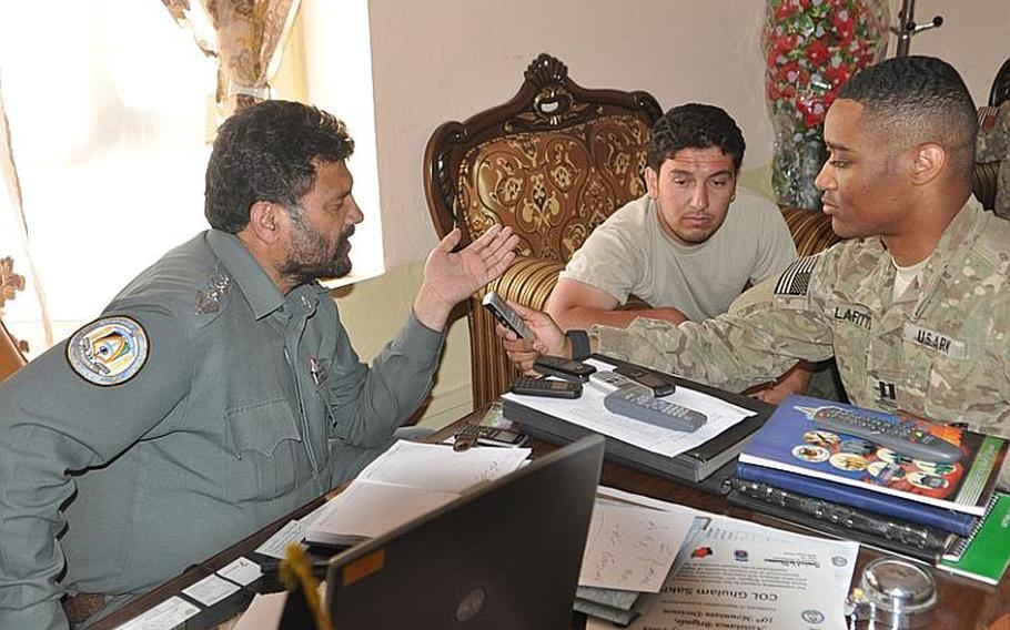 Capt. Westly LaFitte, right, records a statement by Ghulam Sakhi, left, the police chief of Logar province, that will be broadcast over the radio in villages across Logar.