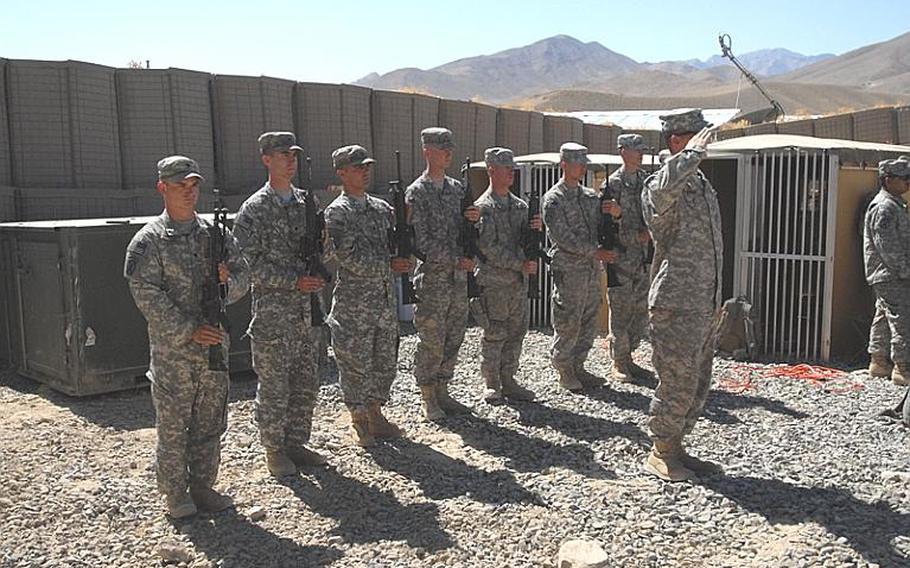 Spc. Justin Chavez, left, and other soldiers in an honor guard at the memorial service for Sgt. Aaron Smith, left, and Private 1st Class Brandon Owens, who were killed Oct. 2, 2009, by an Afghan police officer known to Americans as Crazy Joe.