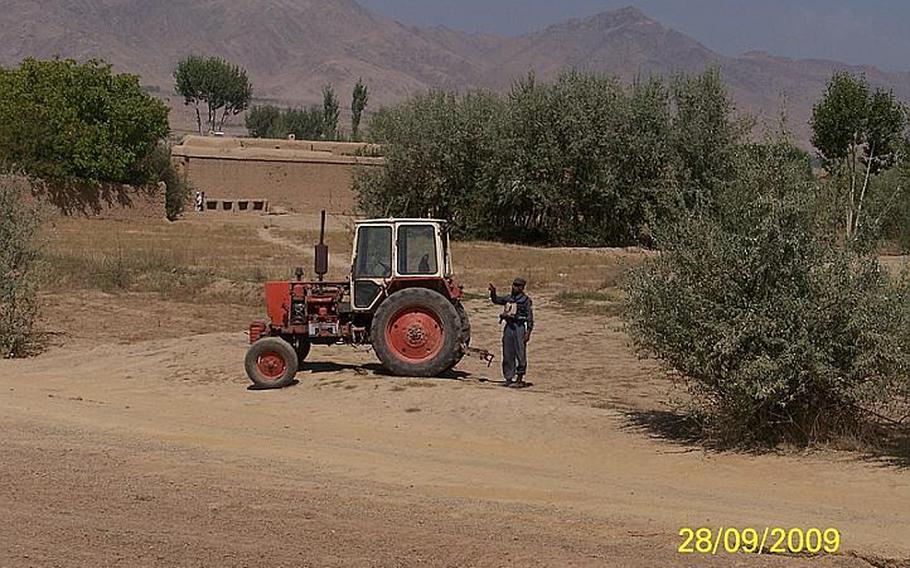 Said Kabeer, an Afghan police officer known to the U.S. troops who trained and patrolled with him as Crazy Joe, gestures at a tractor in Wardak Province, Afghanistan, days before he opened fire on American soldiers.