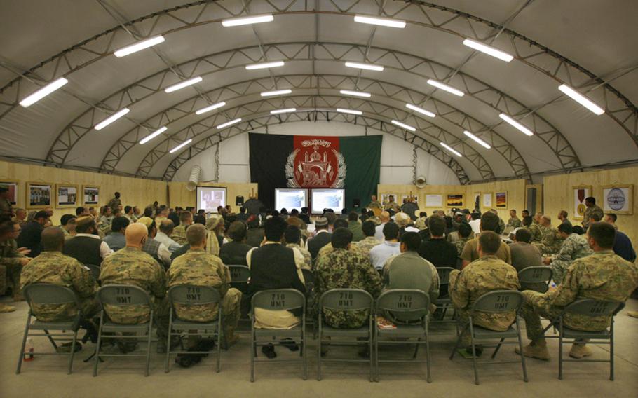 U.S. and Afghan forces along with Afghan local national listen during a Taliban reintegration shura Thursday at Forward Operating Base Pasab, Afghanistan.