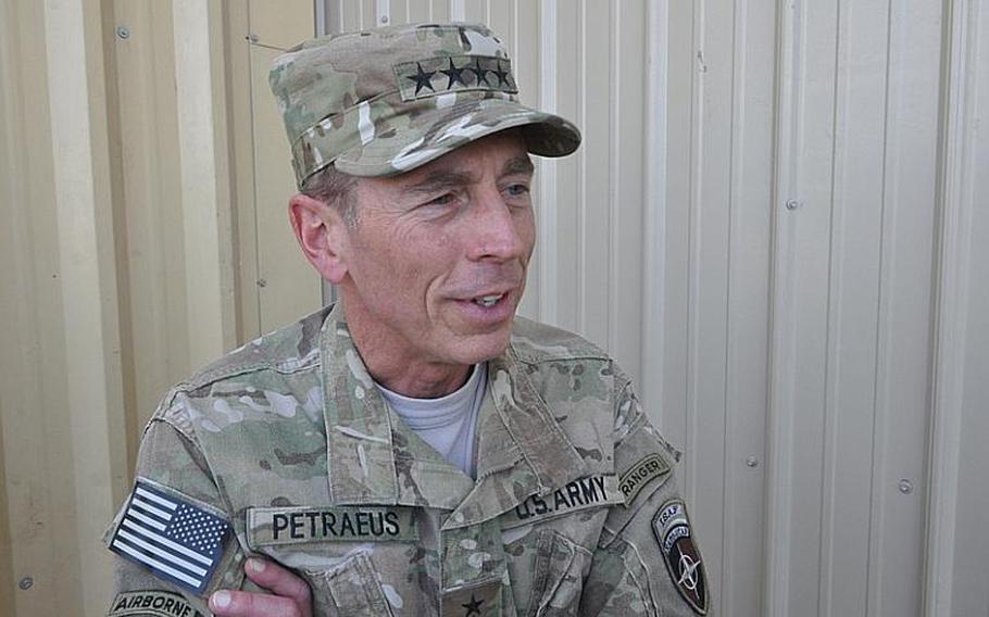 Gen. David Petraeus, outgoing commander of U.S. and NATO forces in Afghanistan, talks after presiding over a re-enlistment ceremony at Bagram Airfield in eastern Afghanistan on Independence Day.