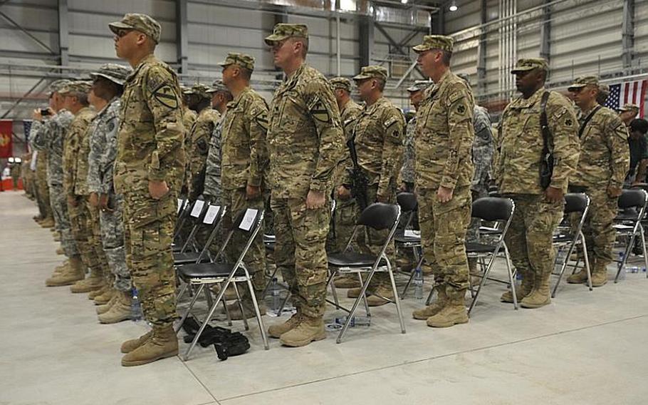Soldiers stand at attention while taking part in a re-enlistment ceremony led by Gen. David Petraeus at Bagram Airfield in eastern Afghanistan on Independence Day.