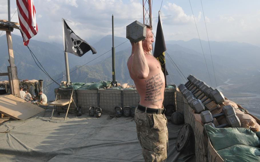 Sgt. Christopher Mitchell, a platoon leader with the 3rd Brigade Combat Team of the 25th Infantry Division, works out last week in the open-air gym at Observation Point Mustang in eastern Kunar province.
