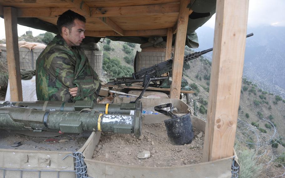 Spc. Jacob Green of the 3rd Brigade Combat Team of the 25th Infantry Division insulates himself from the morning chill while on guard duty last week at Observation Point Mustang in eastern Kunar province.