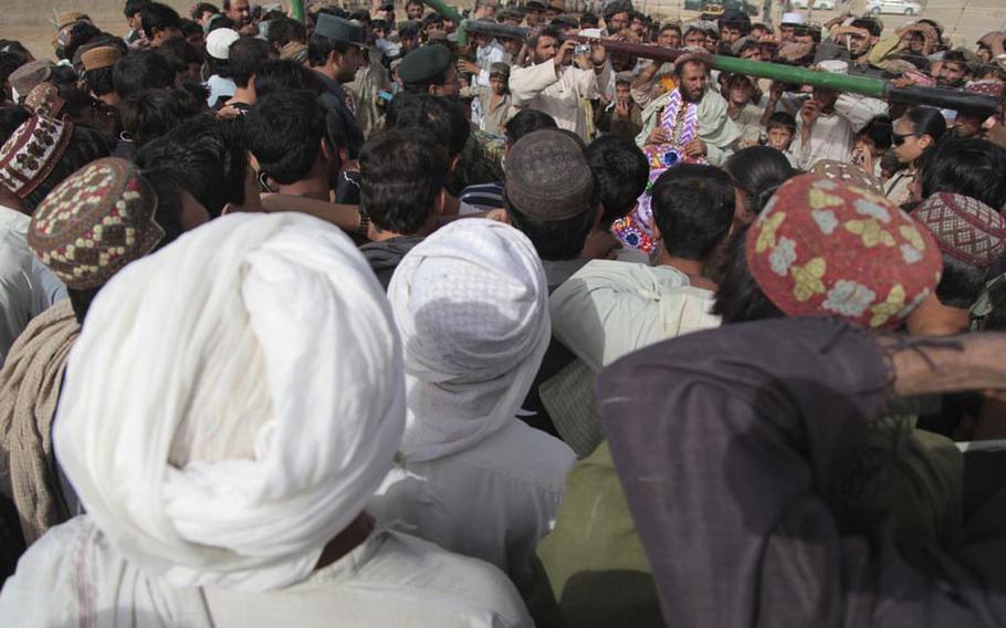 Afghans gather for a ribbon cutting July 28 at the new soccer field on the edge of Safar Bazaar.