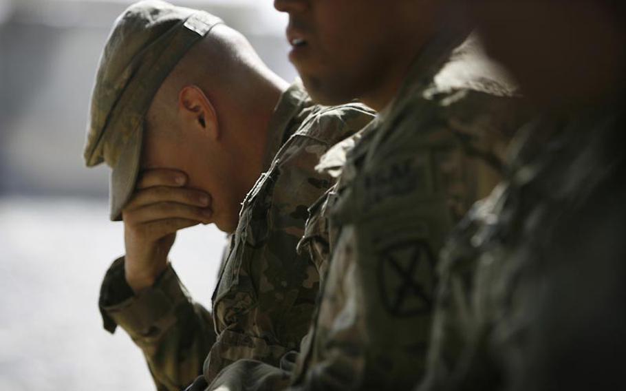 Sgt. Jedidiah Gallina grieves the loss of his fellow soldiers from Company C, 1st Battalion, 32 Infantry Regiment, 3rd Brigade Combat Team, 10th Mountain Division during a Saturday memorial service at Forward Operating Base Howz-e-Madad, Afghanistan. The memorial service was held in honor of five soldiers killed in an improvised explosive device attack on August 11 near Combat Outpost Nalgham.