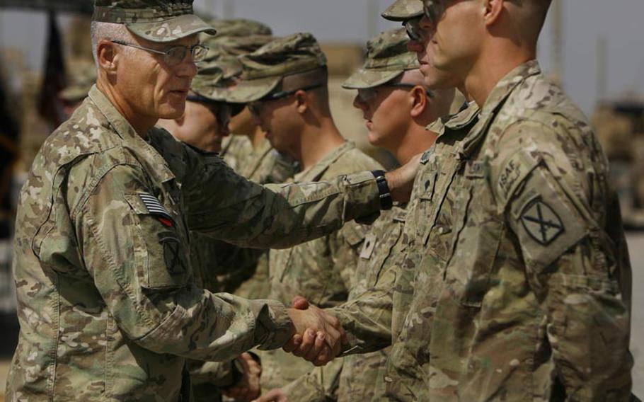 Regional Command-South Commander Maj. Gen. James Terry greets soldiers from Company C&#39;s 3rd platoon during a Saturday memorial service at Forward Operating Base Howz-e-Madad, Afghanistan. The memorial service was held in honor of five soldiers killed in an improvised explosive device attack on August 11 near Combat Outpost Nalgham.