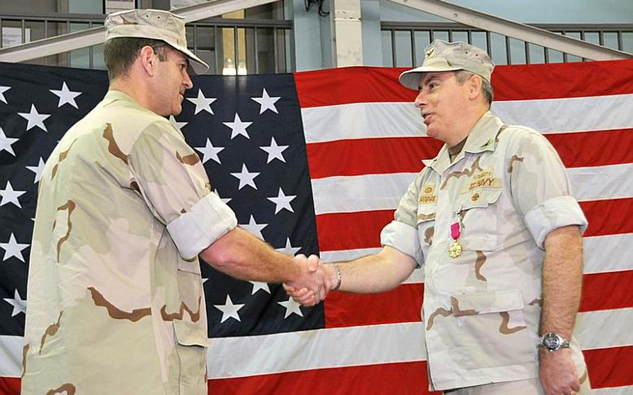 Capt. David Geisler, left, shakes hands with Capt. Donald Hodge after relieving him as Commander, Task Force 53 at a Jan. 9 ceremony in Muharraq, Bahrain. On Oct. 17, 2011, Geisler was relieved for loss of confidence in his ability to command.
