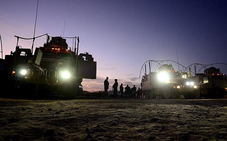 Soldiers from 2nd Battalion, 5th Cavalry Regiment, 1st Brigade, 1st Cavalry Division, prepare to conduct a night patrol from Contingency Operating Station Kalsu near the city of Hilla, Iraq.