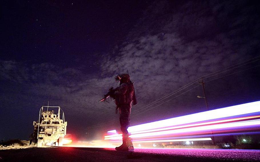 Sgt. Steven Spurrell, with 2nd Battalion, 5th Cavalry Regiment, 1st Brigade, 1st Cavalry Division, scans the area during a night patrol from Contingency Operating Station Kalsu near the city of Hilla, Iraq.
