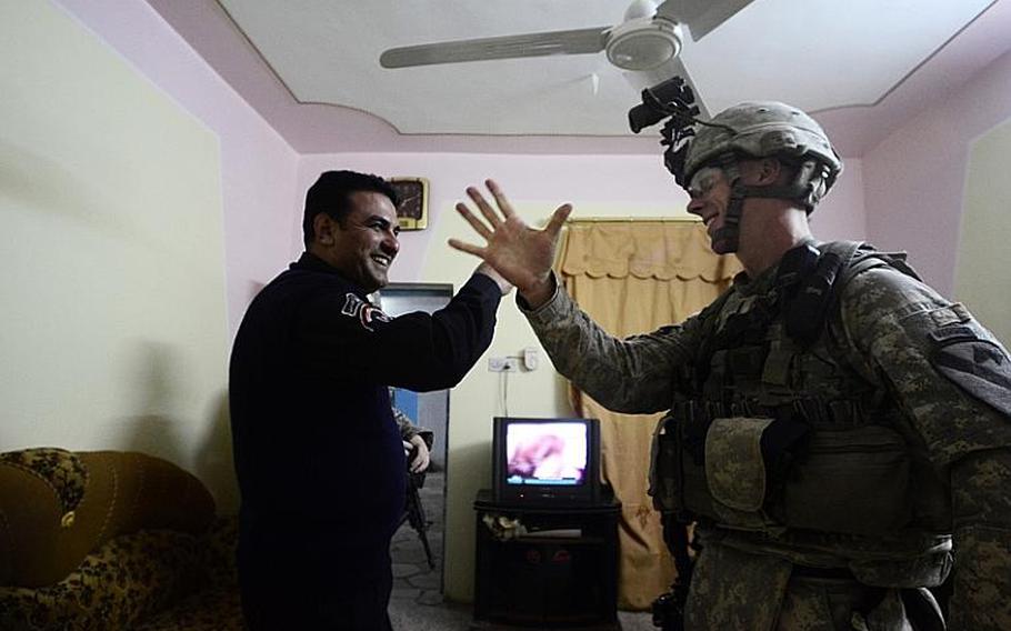 First Lt. David Coleman, with 2nd Battalion, 5th Cavalry Regiment, 1st Brigade, 1st Cavalry Division, visits an Iraqi police station during a night patrol conducted from Contingency Operating Station Kalsu near the city of Hilla, Iraq.