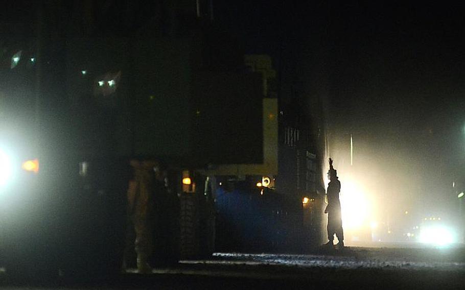 A group of U.S. soldiers in the last convoy to leave Iraq file through the Kuwait border at the Khabari crossing.
