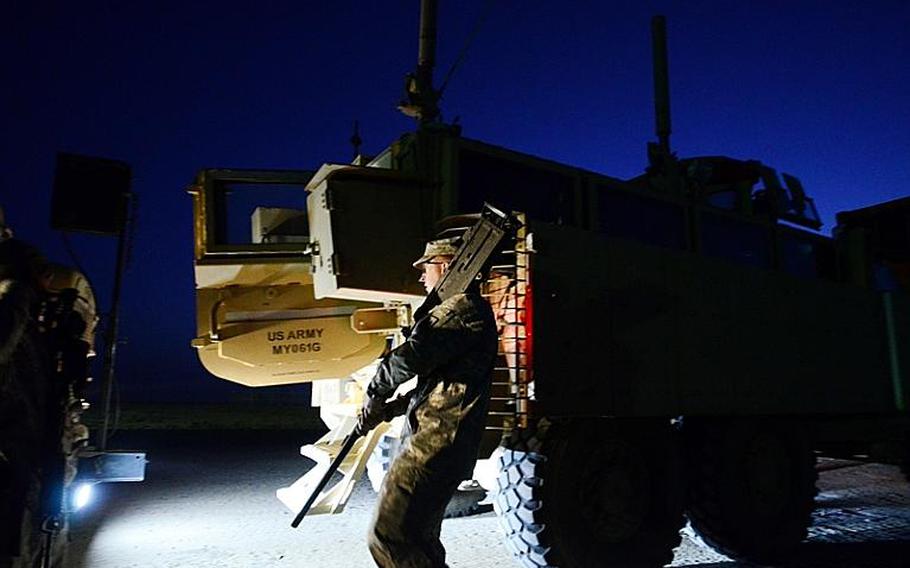 U.S. soldiers in the last convoy to leave Iraq clear their weapons after safely crossing the Kuwait border at the Khabari crossing.

