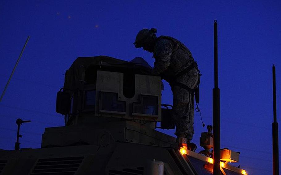 U.S. soldiers in the last convoy to leave Iraq clear their weapons after safely crossing the Kuwait border at the Khabari crossing.