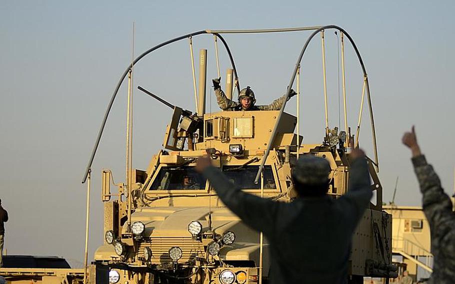 U.S. soldiers cheer for each other as the last U.S. military convoy to exit Iraq files across the Kuwait border from Iraq at the Khabari crossing on Dec. 18, 2011. 
