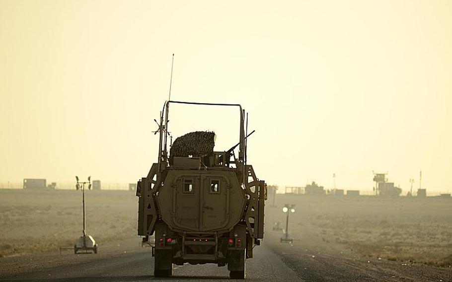 The last U.S. military vehicle to exit Iraq drives into the sunrise Dec. 18, 2011, after trailing its convoy across the Kuwait border at the Khabari crossing.