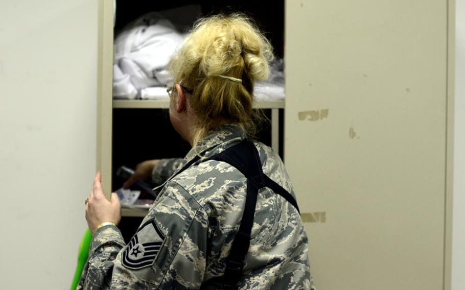 Master Sgt. Margaret Williams, one of the last U.S. airmen to leave Iraq, tidies her office at Ali Air Base in Tallil, Iraq, for the last time.