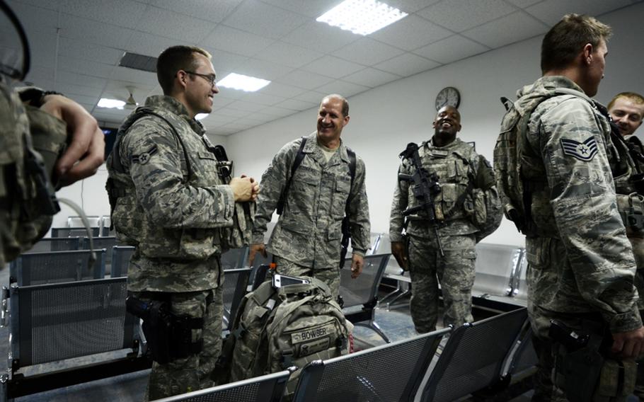 Command Chief Master Sergeant for the 321st Air Expeditionary Wing Jerry Delebreau, center, visits with Airman 1st Class Chase Bowser, left, and Staff Sgt. Sidney Davis at Ali Air Base, Tallil, moments before leaving Iraq as the last U.S. airmen to go. "It&#39;s a surreal day," Staff Sgt. Davis said. "It still doesn&#39;t feel like it&#39;s over."