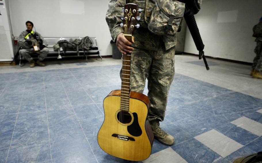 Airman 1st Class Simeon Tidwell, who started playing guitar this deployment, is one of the last U.S. airmen to leave Iraq.