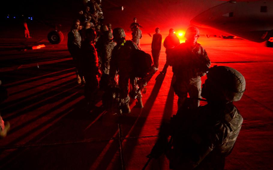 The last U.S. airmen to leave Iraq are greeted by the Air Force leadership in Iraq before boarding a C-17 Globemaster at Ali Air Base, Tallil, Iraq and beginning their journey home.