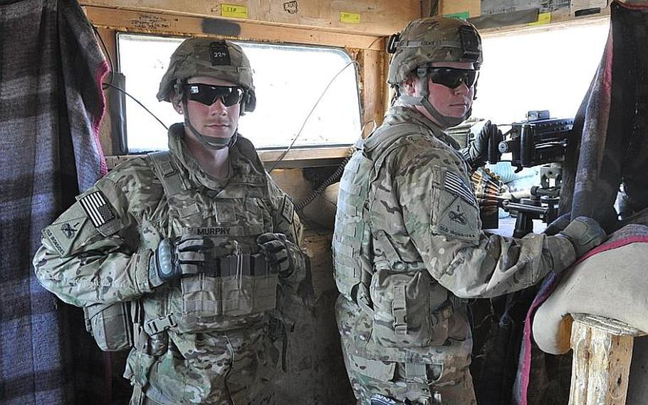 Pvt. James Murphy, left, and Pfc. Erik Koenig pull duty in a watch tower at Combat Outpost Nerkh in Wardak province, 40 miles southwest of Kabul. Referring to tensions between U.S. and Afghan troops, Koenig said troops kept their guard up before, but now are even more aware.