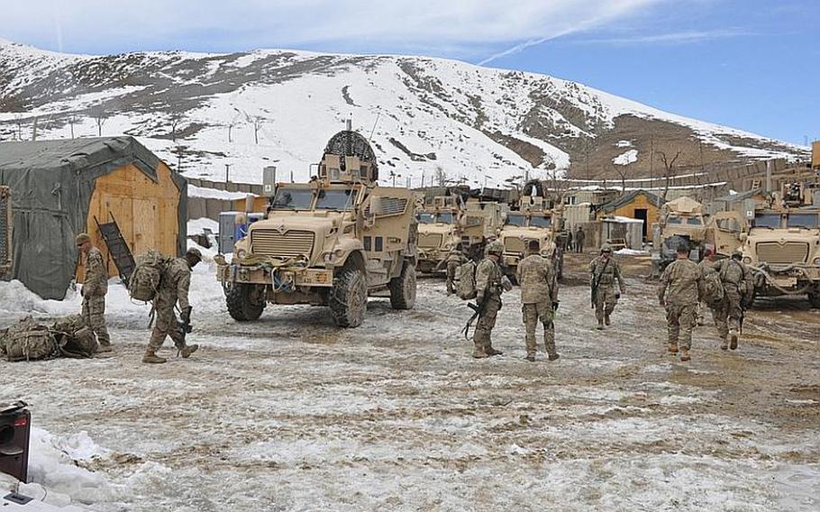A platoon with Company A of the 1st Battalion, 41st Infantry Regiment unloads gear after arriving at a joint security station, occupied by U.S. and Afghan soldiers, near the village of Nerkh in Wardak province, 40 miles southwest of Kabul.