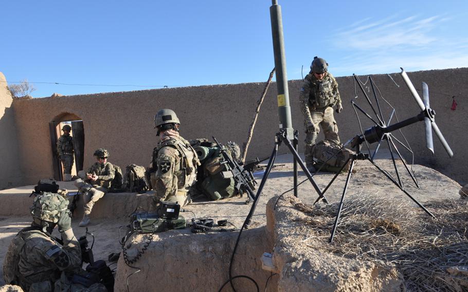 An ad hoc joint tactical air control command post set up by Staff Sgt. Andy Carpenter, right, and Airman 1st Class Travis Holland (left of the rifle) during a recent Army infantry mission to Ghorak district, Kandahar province.