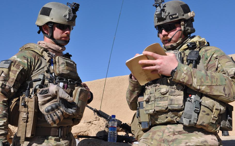 Staff Sgt. Andy Carpenter and Airman 1st Class Travis Holland coordinate monitoring of an infantry air assault.