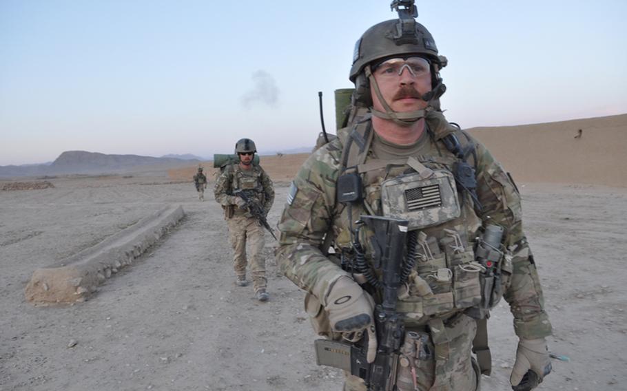 Staff Sgt. Andy Carpenter, foreground, and Airman 1st Class Travis Holland on an Army infantry air assault in Ghorak district, Kandahar province.