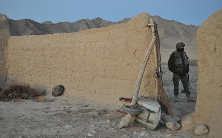 An Afghan soldier patrols outside of a mud wall compound in Ghorak district, Kandahar province, during a recent joint U.S.-Afghan mission to the remote Taliban-influenced area. It could be a make or break year for U.S. forces in Kandahar, as commanders prepare for a planned drawdown that will begin in earnest this summer with the reduction of 30,000 U.S. troops.